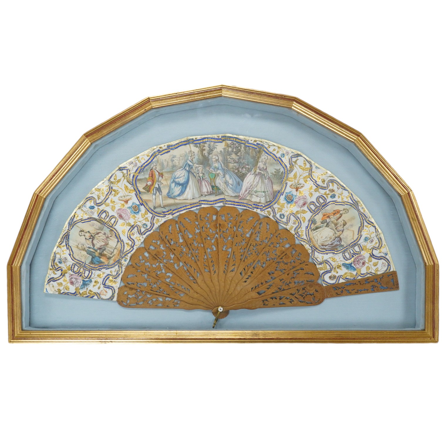 A gilt framed 19th century Spanish hand painted and decorated paper and sandalwood fan, from the Norte collection, the leaf painted with a central figurative cartouche and two others, surrounded with floral decoration an